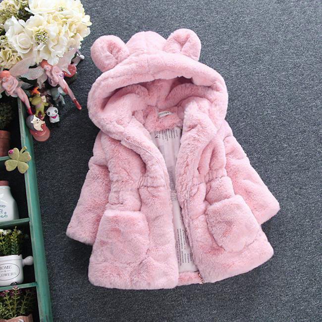 Pink faux fur hooded coat with bear ears, plush texture, relaxed fit, and front pockets