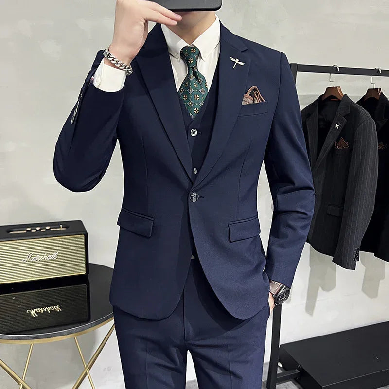 Slim fit navy blue suit with matching vest, white dress shirt, and patterned tie