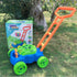 Colorful plastic bubble lawn mower toy with green wheels and orange handle on grass