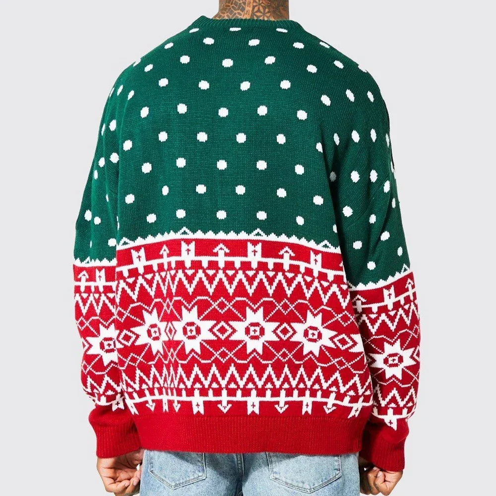 Man wearing loose fit, knitted Christmas sweater with green polka dot top and red geometric pattern