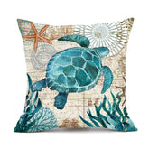 Decorative throw pillow with blue sea turtle, starfish, and ocean plants on a vintage map background