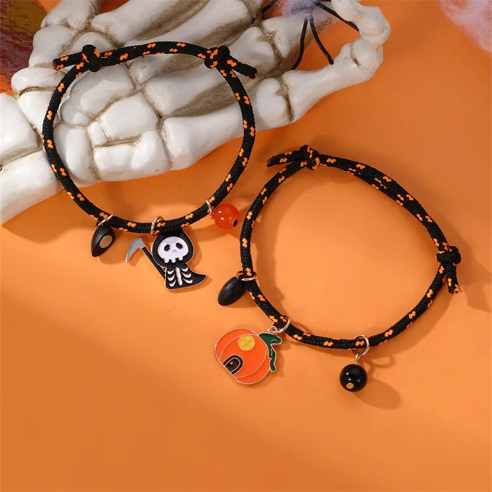 Black and orange woven Halloween bracelets with pumpkin and skeleton charms on orange background