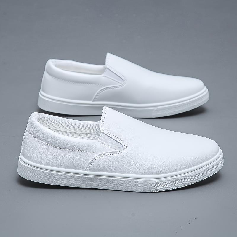 White slip-on sneakers with smooth faux leather upper and minimalist streetwear style