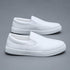 White slip-on sneakers with smooth faux leather upper and minimalist streetwear style