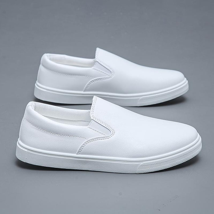 White slip-on sneakers with smooth faux leather upper and minimalist streetwear style