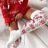 Red and white knit sweater dress with festive patterns, paired with cozy over-the-knee socks.