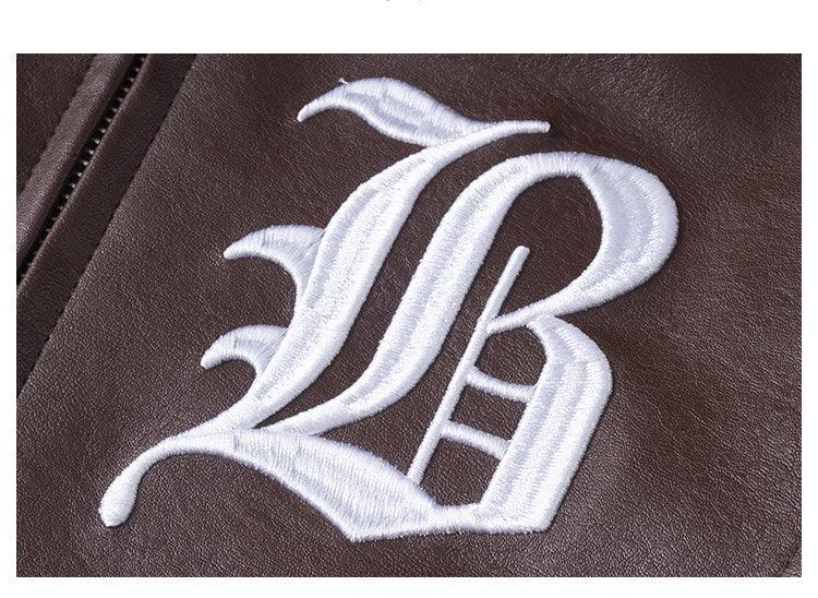 Brown faux leather jacket with white embroidered gothic letter design, close-up view