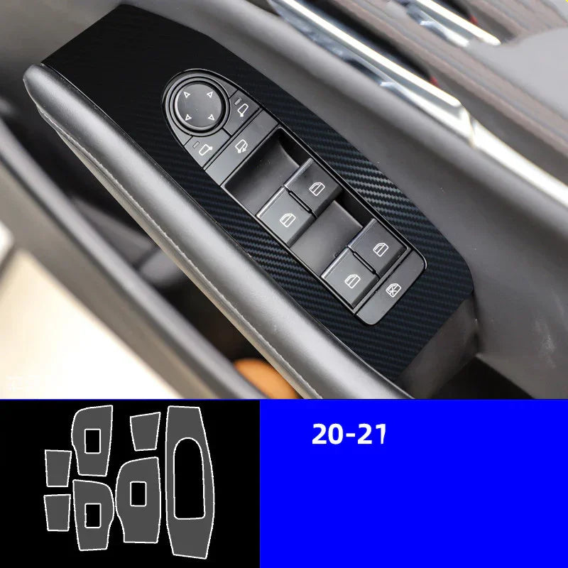 Close-up of black carbon fiber car window switch panel trim with window control buttons
