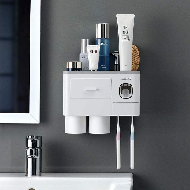 Wall-mounted white bathroom organizer with toothbrush holder, cups, and skincare storage
