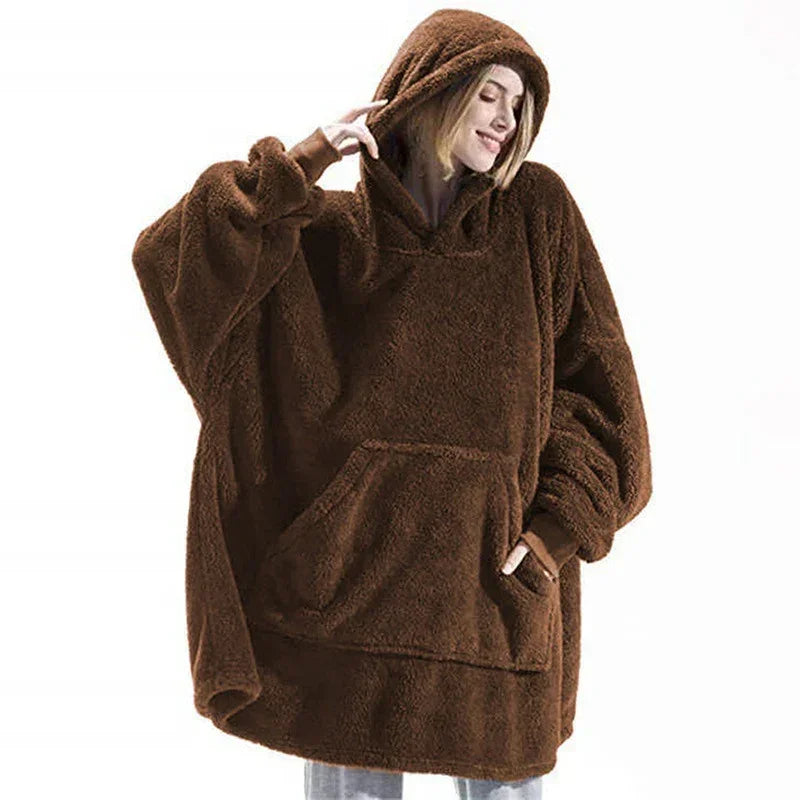 Woman wearing oversized brown fleece hoodie with large pocket and relaxed fit.