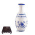 Blue and white porcelain style puzzle vase with floral patterns and black display stand