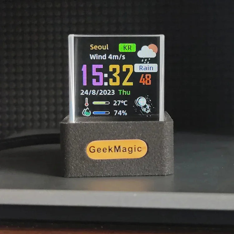 Compact digital desktop clock with color display, weather info, and black rectangular base