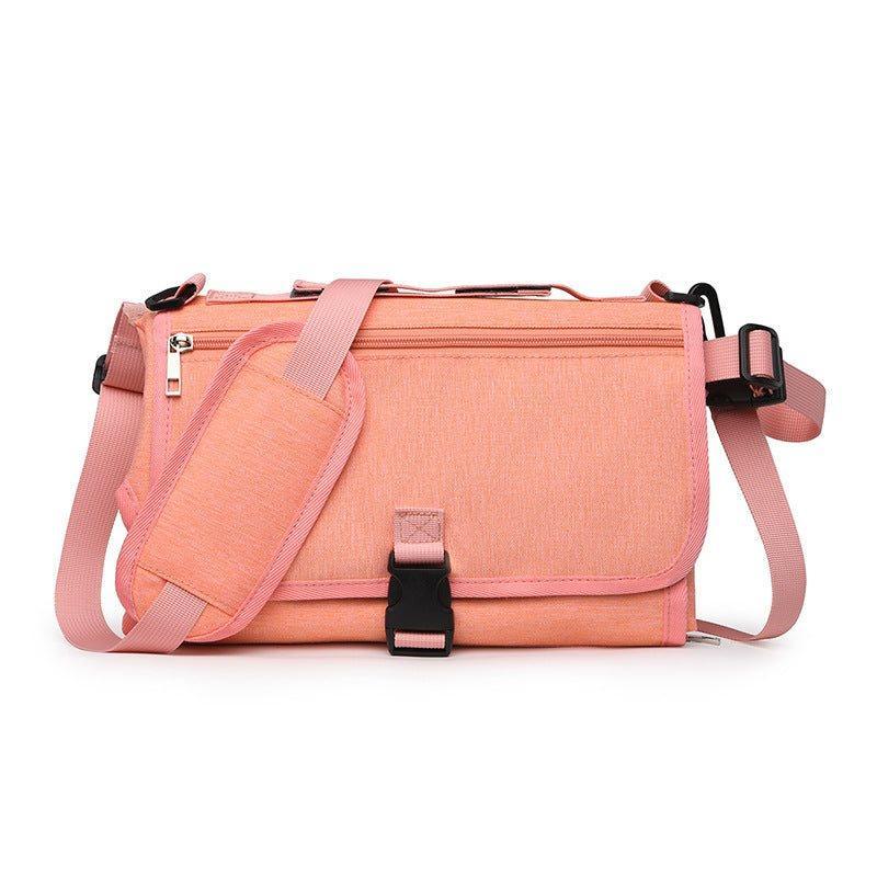 Pink crossbody messenger bag with adjustable strap, durable fabric, and front buckle closure