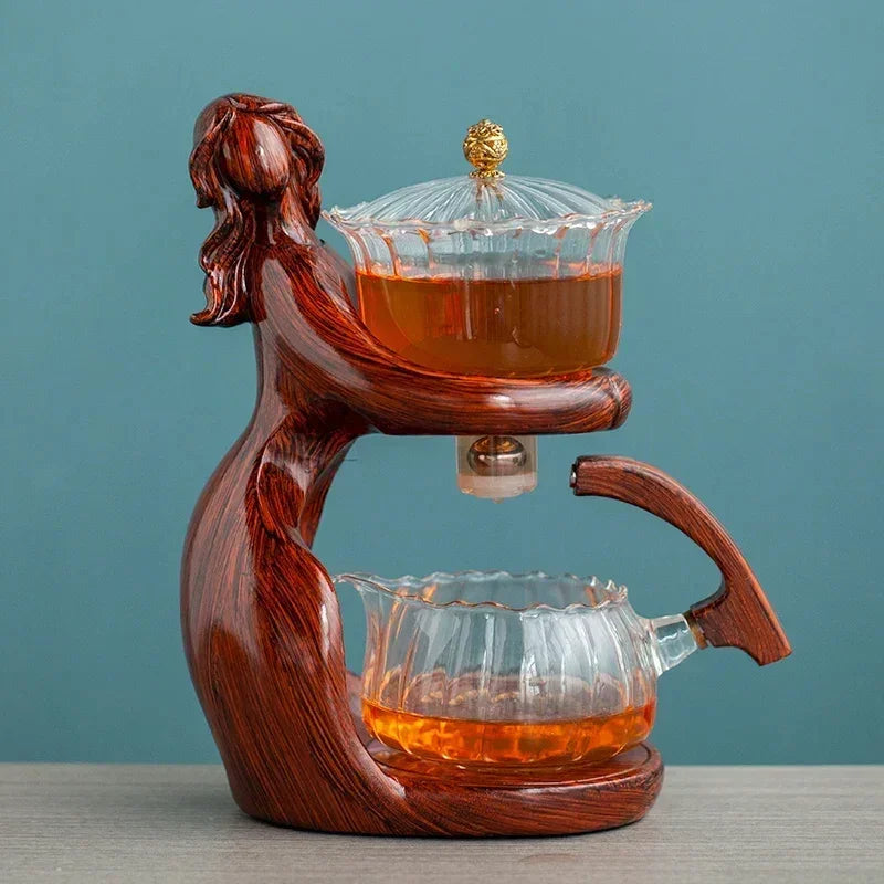 Sculpted wooden tea set holder with clear glass teapot and cup, modern artistic design