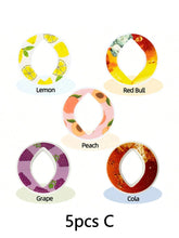 Set of five round silicone rings with fruit and drink designs in lemon, peach, grape, cola, and Red Bull patterns.
