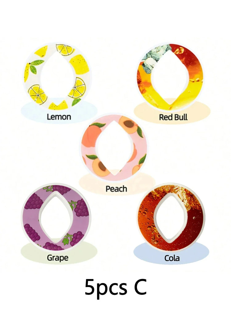 Set of five round silicone rings with fruit and drink designs in lemon, peach, grape, cola, and Red Bull patterns.