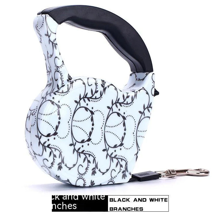 Retractable dog leash with black and white branch pattern, ergonomic plastic handle