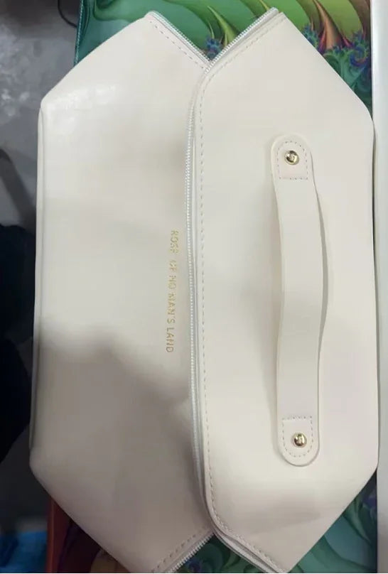 Cream-colored geometric clutch bag in smooth leather with top handle and zipper closure
