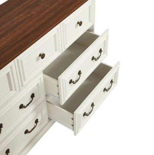 White wooden dresser with antique brass handles, brown top, and open drawers