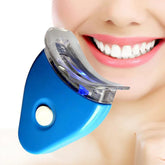 Person using a blue LED teeth whitening mouthpiece for dental care