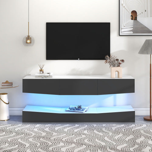 Grey particleboard hanging TV stand with LED lighting and storage shelves under a wall-mounted TV in a modern living room setting
