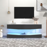 Grey particleboard hanging TV stand with LED lighting and storage shelves under a wall-mounted TV in a modern living room setting