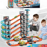 Two boys playing with a colorful multi-level toy car racetrack set, wearing casual clothes.