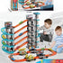 Two boys playing with a colorful multi-level toy car racetrack set, wearing casual clothes.