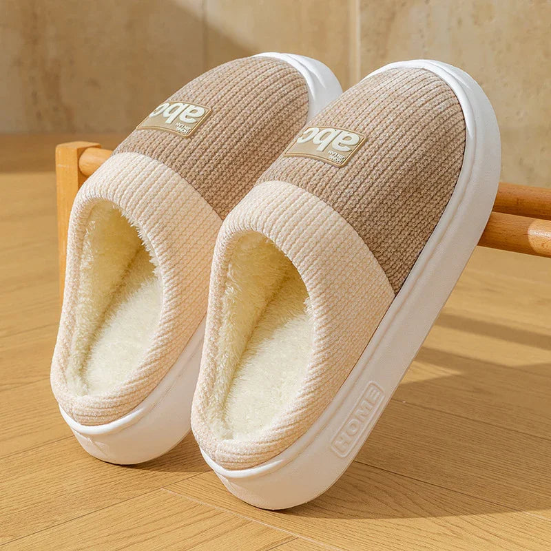 Cozy beige and tan ribbed indoor slippers with plush fleece lining and thick rubber sole