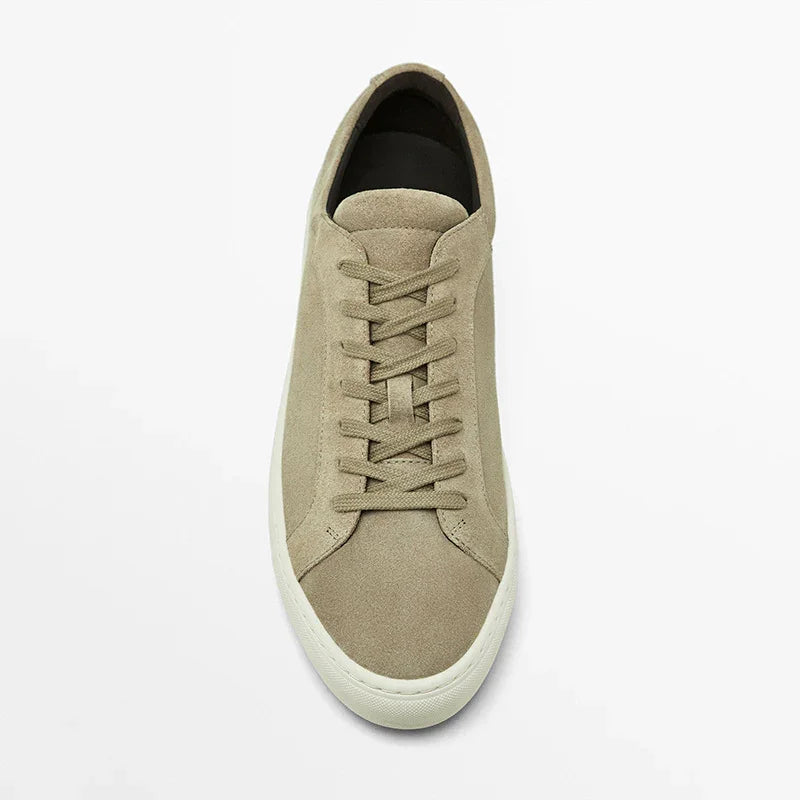 Beige suede low-top sneaker with lace-up closure and white rubber sole, minimalist style