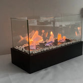 Modern tabletop glass fireplace with white decorative stones and three visible flames