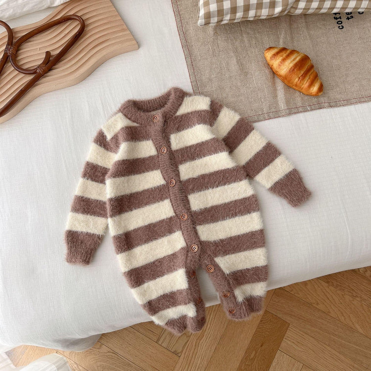Brown and cream striped fuzzy knit baby romper with front buttons, laid flat on a bed