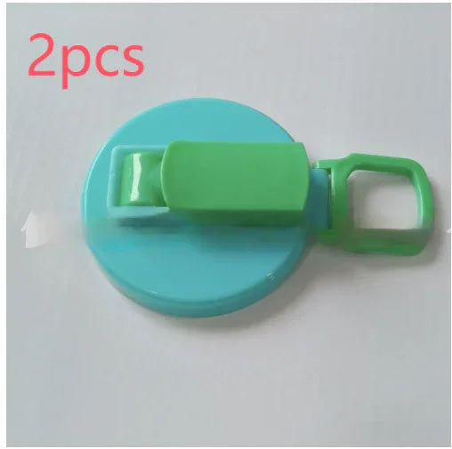 Two-piece set of round plastic bag clips in blue and green with secure locking design.