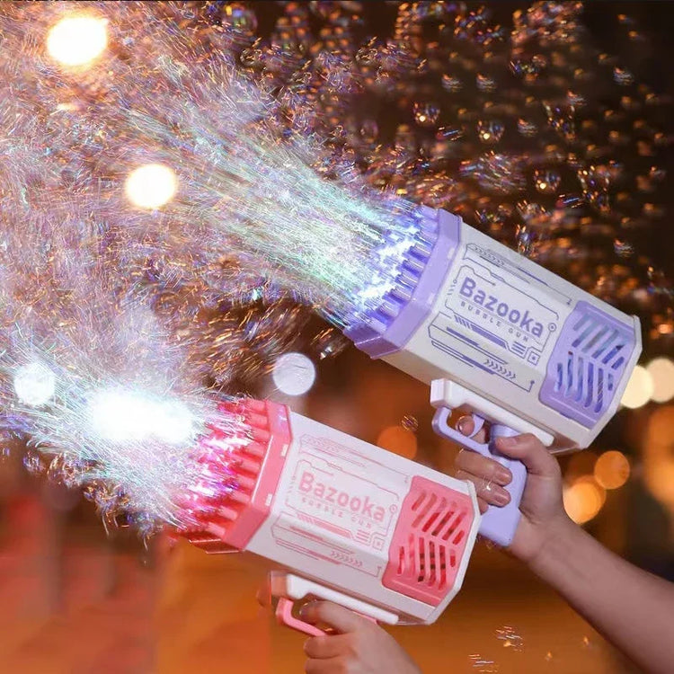 Hands holding colorful plastic bubble guns with LED lights blowing bubbles outdoors at night