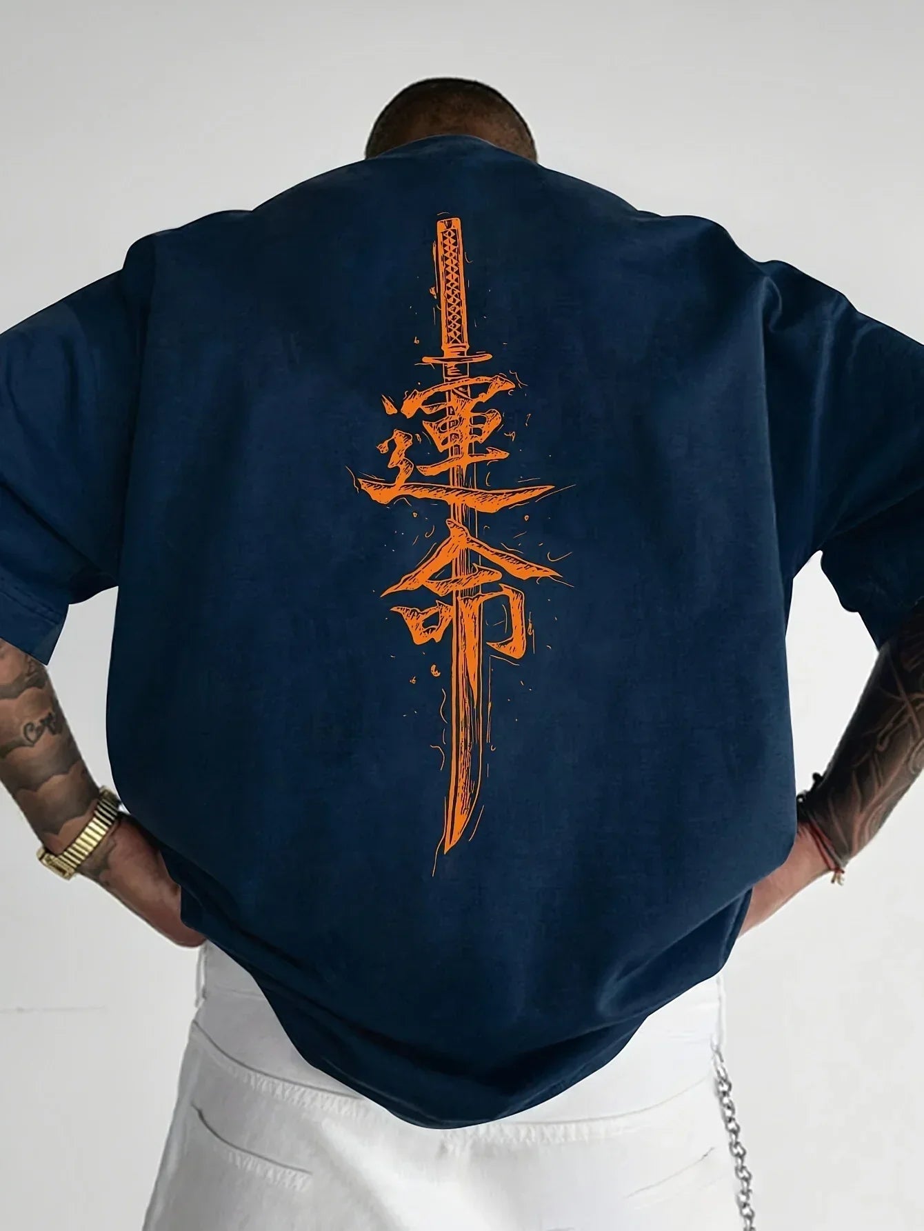 Oversized navy blue streetwear shirt with bold orange sword and kanji graphic on back