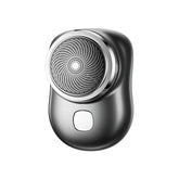 Sleek black metallic electric shaver with ergonomic design and circular mesh blade head