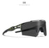 Futuristic black sunglasses with non-mirrored lenses and green splatter detail, sporty fit.