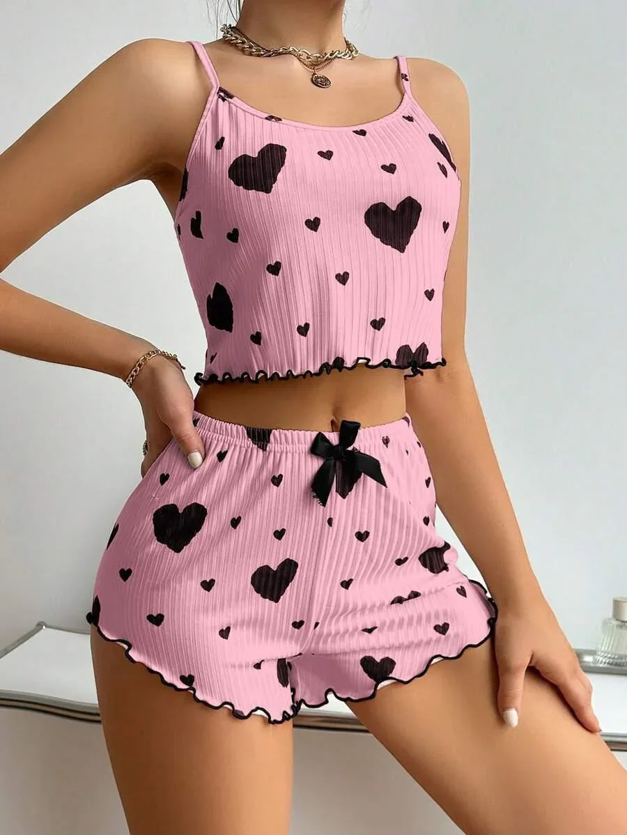 Pink ribbed crop top and shorts set with black heart print, ruffled hems, relaxed fit
