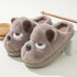 Brown plush bear slippers with cartoon face, cozy fleece material, slip-on fit, indoor footwear