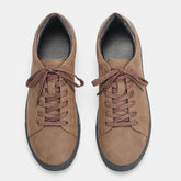 Brown suede low-top sneakers with matching laces, black rubber soles, casual fit