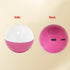 Pink and white spherical tech accessory with USB port and speaker, modern gadget design.