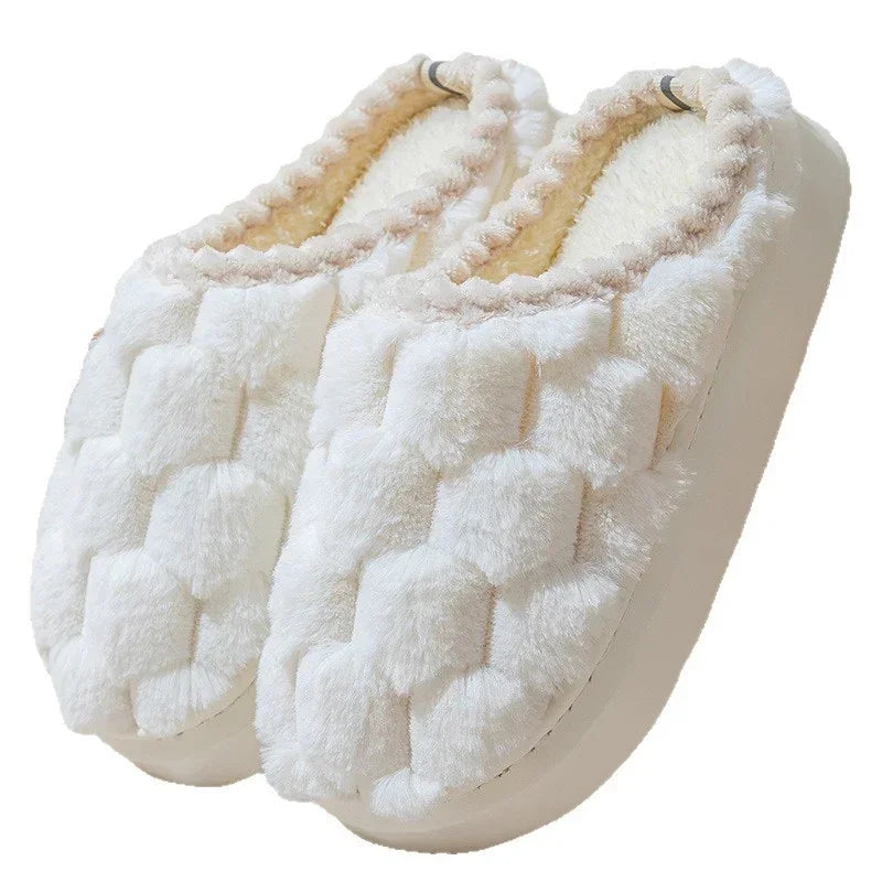 Plush white slip-on slippers with textured woven pattern and soft, cozy lining