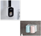 Wall-mounted bathroom organizer with black and white soap dispenser and pastel blue and pink cups