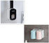 Wall-mounted bathroom organizer with black and white soap dispenser and pastel blue and pink cups