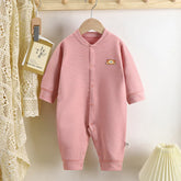 Pink striped baby romper with long sleeves, front snaps, and bear patch, soft cotton fabric