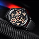 Black leather strap watch with exposed gold gears and modern skeleton dial design