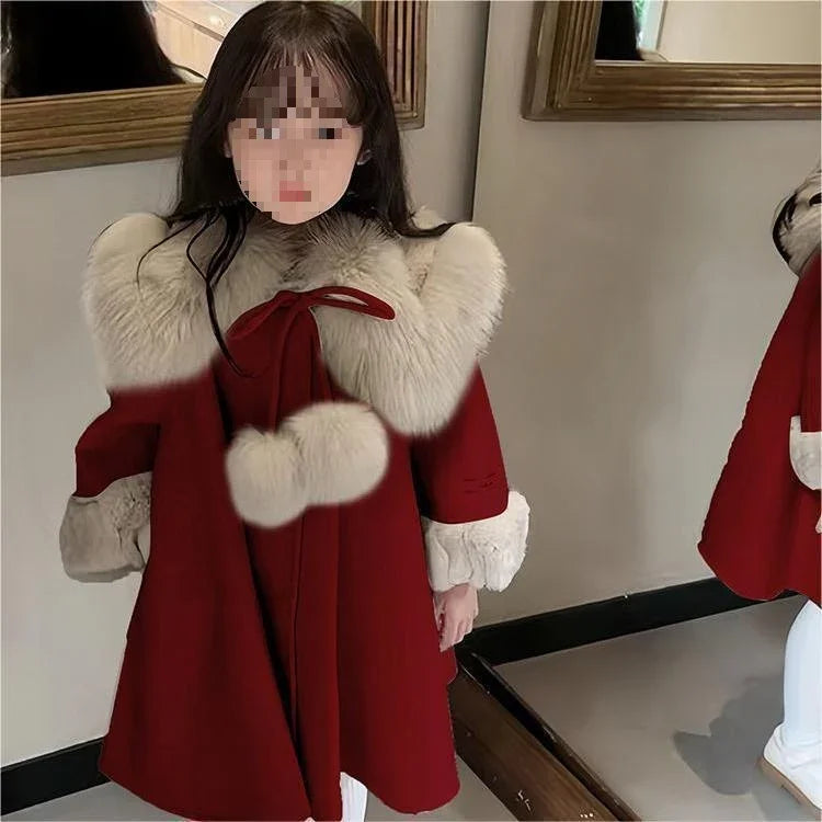 Girl wearing red winter coat with white faux fur collar, cuffs, and pom pom detail, loose fit