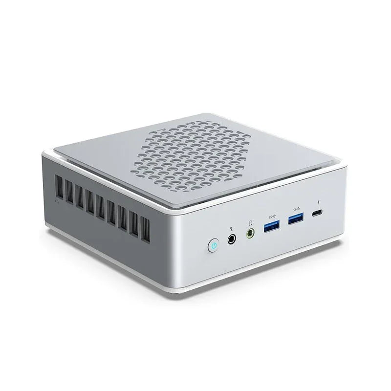 Compact silver mini PC with ventilation, USB ports, and headphone jacks on white background