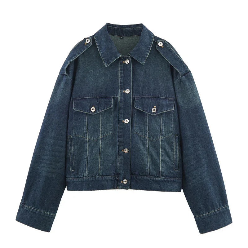 Dark blue denim jacket with button front, oversized fit, chest flap pockets, and shoulder epaulets