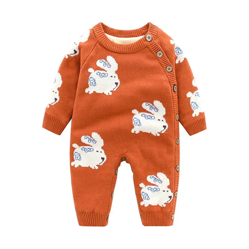Rust orange knit baby romper with white bunny pattern, long sleeves, and front buttons